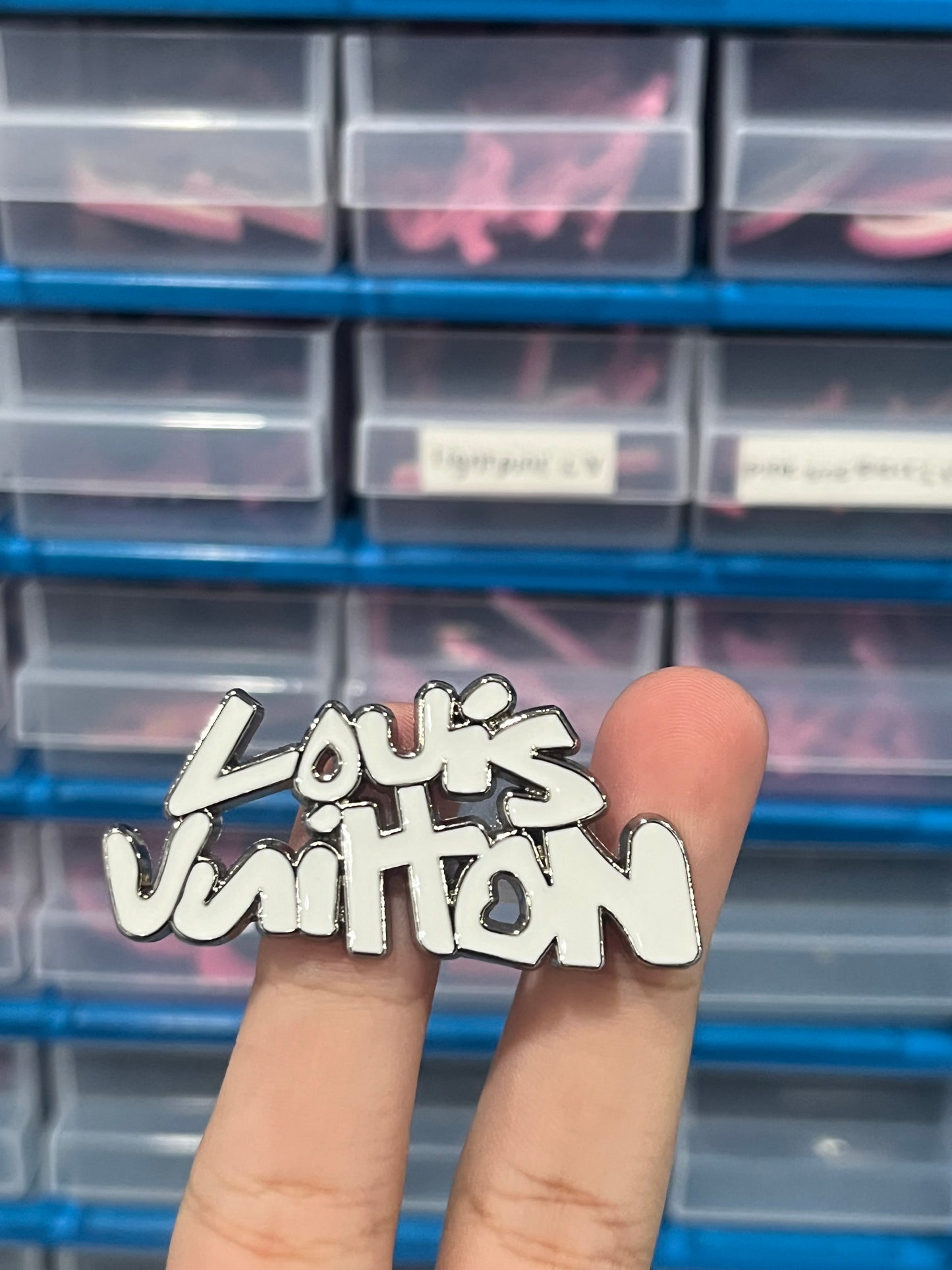 White L v metal charm