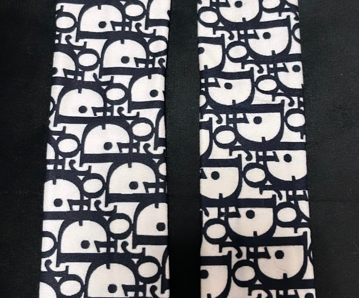 White and black pattern D straps